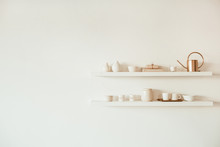 Kitchenware Utensils On Shelf On White Background. Mugs, Cups, Teapot, Tray, Decorations. Stylish Modern Kitchen Design Concept.