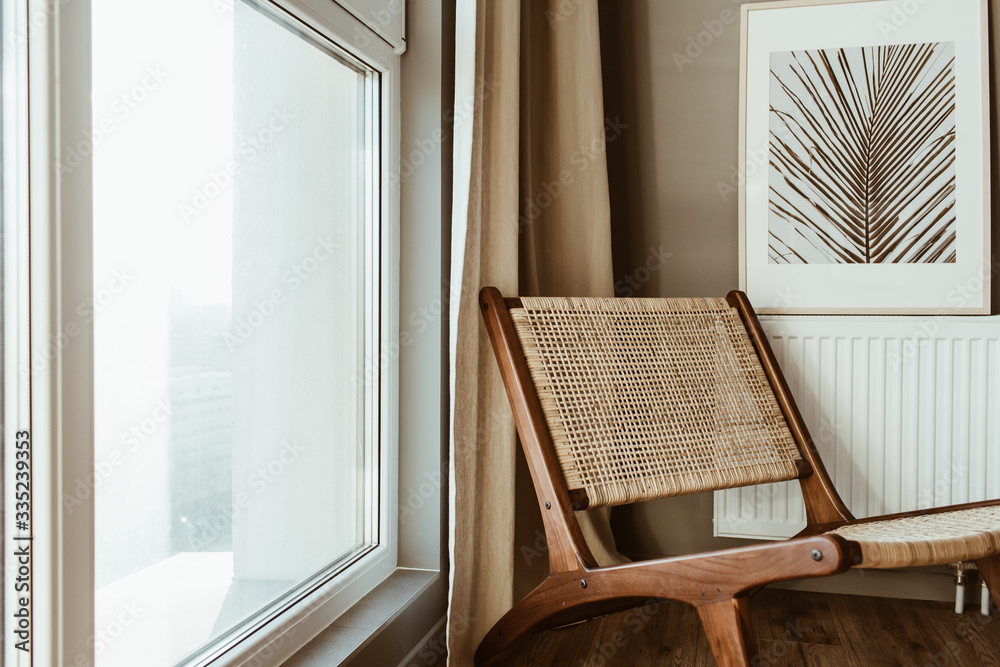 Modern interior design concept. Stylish rattan wooden chair, window, curtains. Minimal comfortable cozy living room. - obrazy, fototapety, plakaty 