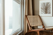Modern interior design concept. Stylish rattan wooden chair, window, curtains. Minimal comfortable cozy living room.