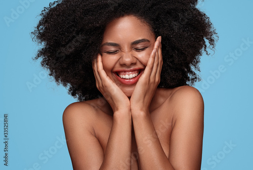 Fotografía Happy African American woman with perfect skin on blue background
