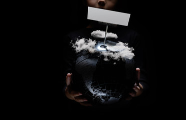 Wall Mural - kid hands hold globe under cloudy sky over black