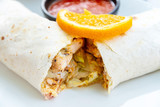 Fototapeta Tulipany - Mexican fajita wraps with grilled chicken fillet and fresh vegetables