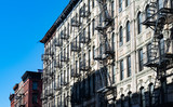 Fototapeta Miasta - Old Residential Buildings with Fire Escapes on the Lower East Side of New York City
