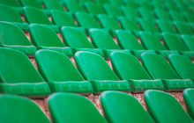 Rows Of Green Tribunes In A Huge Stadium