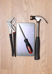 Work tools and modern smartphone on a wooden board. Homework Image