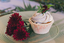 Cup Cake On A Plate With Red Flowers