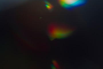 Wall Mural - lens flare and light leak haze texture on a black background.