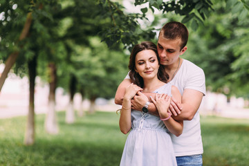 Loving couple on a city street. Portrait of a guy and a girl of love story. Life style