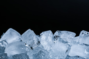 Wall Mural - Ice cubes on black background, closeup view