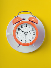 cup of clock. red retro alarm clock on  red background. Round red alarm clock. ten hours ten minutes of the morning time to get up to wake up and have breakfast morning or evening jog to go to work