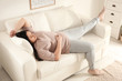 Lazy overweight woman sleeping on sofa at home