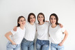 © New Africa - Beautiful young ladies in jeans and white t-shirts on light background. Woman's Day