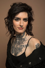 Portrait Of Confident Transgender Woman With Tattoos And Nose Ring