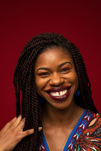 Portrait Of Happy Gap Toothed Woman With Long Black Braids