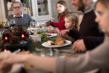 Extended Family Giving Thanks Before Having Christmas Dinner