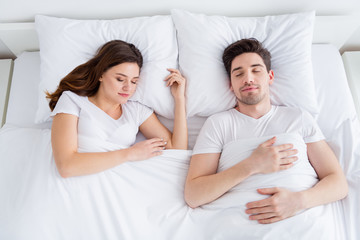 Sticker - High angle above view photo of pretty lady handsome guy couple lying sheets bed covered white blanket enjoy weekend saturday morning awakening eyes closed wear pajama room indoors