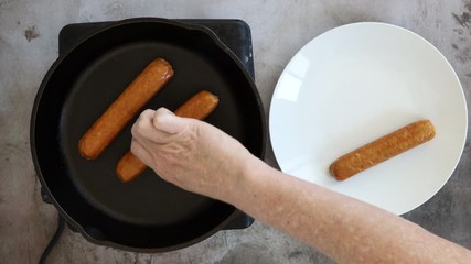 Wall Mural - Grilling Hot Dogs in a Pan