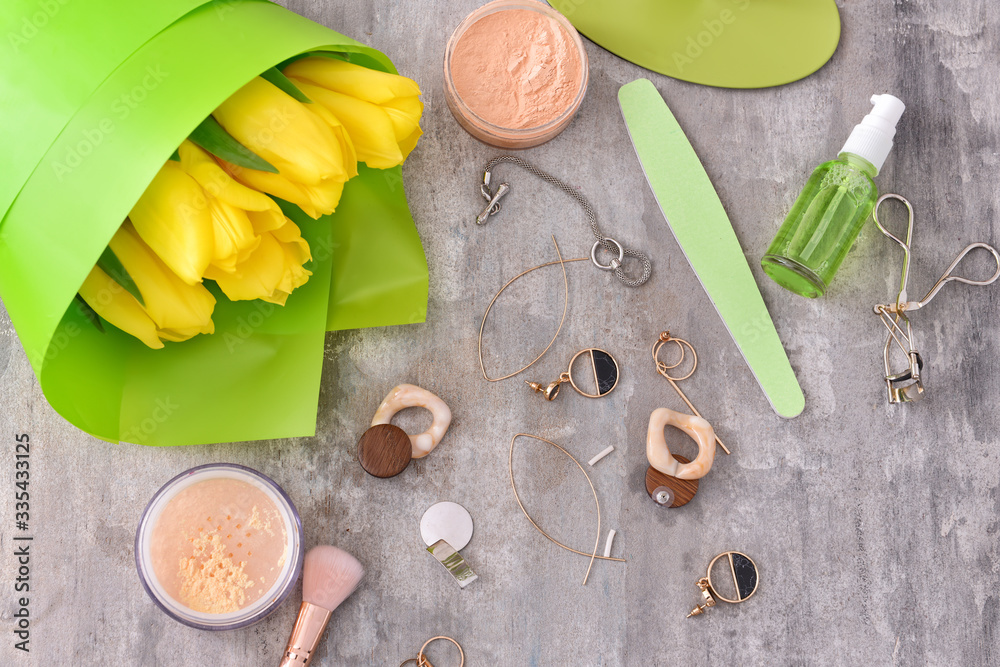 Accessories with makeup cosmetics on grey background