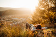 © eldarnurkovic - Carefree happy woman lying on green grass meadow on top of mountain enjoying sun on her face.Enjoying nature sunset.Freedom.Relaxing in mountains at sunrise.Sunshine.Daydreaming.Listening to music