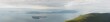 © Colson Struss - panoramic aerial view of sea and islands with cloudy sky in Washington