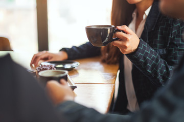 Canvas Print - Closeup image of people enjoyed talking and drinking coffee together in cafe