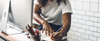 © Art_Photo - Portrait of african american black woman relaxing using technology of desktop computer while sitting on table.Young creative african girl working and write on book at home.work from home concept