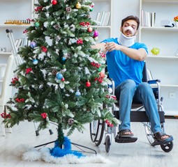 Wall Mural - Injured disabled man celebrating christmas at home