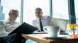 © Yingyaipumi - Meeting and discussion concept.business people communicating in office.Mature businessman discuss information with a colleague in a modern business lounge high up in an office tower.