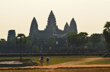 Wall Mural - Travelers and Angkor Wat before sunset