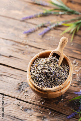 Fotografering Lavender flowers in a wooden bowl