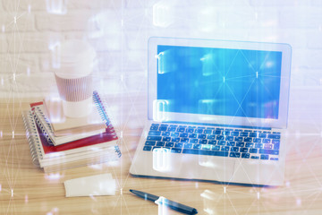 Double exposure of desktop computer and technology theme hologram. Concept of software development.