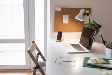 Wall Mural - Laptop on office desk interior. Stylish workplace mockup.