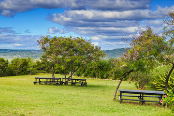 Wall Mural - A picnic area on the top of a green, tropical hillside