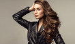 canvas print picture - Beautiful stylish woman wearing  black leather jacket. Fashionable and self-confident girl with long curly hair. Clothing, style and fashion
