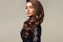 Beautiful Stylish Woman Wearing  Black Leather Jacket. Fashionable And Self-confident Girl With Long Curly Hair. Clothing, Style And Fashion