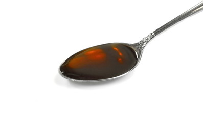 Wall Mural - Spoonful of Cough Medicine isolated on a white background. medication or antipyretic syrup. 