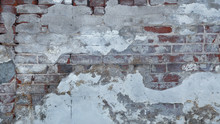 Old Red Brick Wall Background Partially Exposed Under Multiple Layers Of Crumbling Concrete. Copy Space.