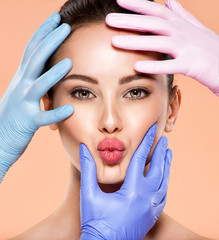 Wall Mural - face skin check before plastic surgery. beautician touching young woman face. doctor in medicine glo