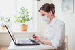 © Konstantin Gorbachev - Coronavirus. Business woman working from home wearing protective mask. Business woman in quarantine for coronavirus wearing protective mask. Working from home.