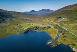 Fototapeta Miasto - Aerial view of Llynau Mymbyr Lake and campsite with Snowdon Horseshoe Mountains in background, Plas Y Brenin, Capel Curig, Snowdonia, Wales, UK