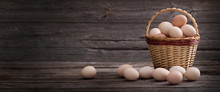 Eggs In Basket On Old  Wooden Background