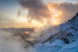 © ClickAlps - Foggy sky at sunset over mountains covered with snow, aerial view, Preda Rossa, Val Masino, Valtellina, Sondrio, Lombardy, Italy
