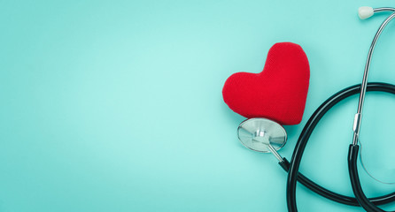 Table top view aerial image of accessories healthcare & medical with Valentines day background concept.telescope with colorful heart shape on pink paper.Flat lay items for doctor using treat patient.