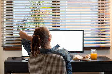 Wall Mural - home office woman working on computer at dusk white screen for copy space