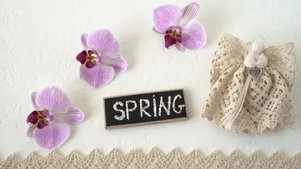 Poster - composition of delicate pink orchids, nameplate with spring, angel and lace