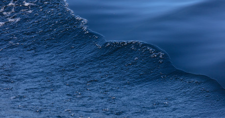 beautiful separation of water into a smooth surface and a storm. Blue Art. Water Banner. Liquid Ice. Icy Pattern. Ocean Texture. Abstract magical blue water. Water Waves Surface as Background