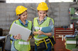 © nikomsolftwaer - young woman asian workplace safety inspector writing a report at industrial factory. Two Asian female workers talked about industrial work