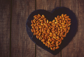 Poster - almonds on wooden surface