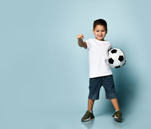 Cute Boy Playing Football, Happy Child, Young Male Teen Goalkeeper Enjoying Sport Game, Holding Ball, Isolated Portrait Of A Preteen Smiling And Having Fun