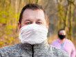 Keeping social distance while walking outside during coronavirus quarantine in homemade face masks
